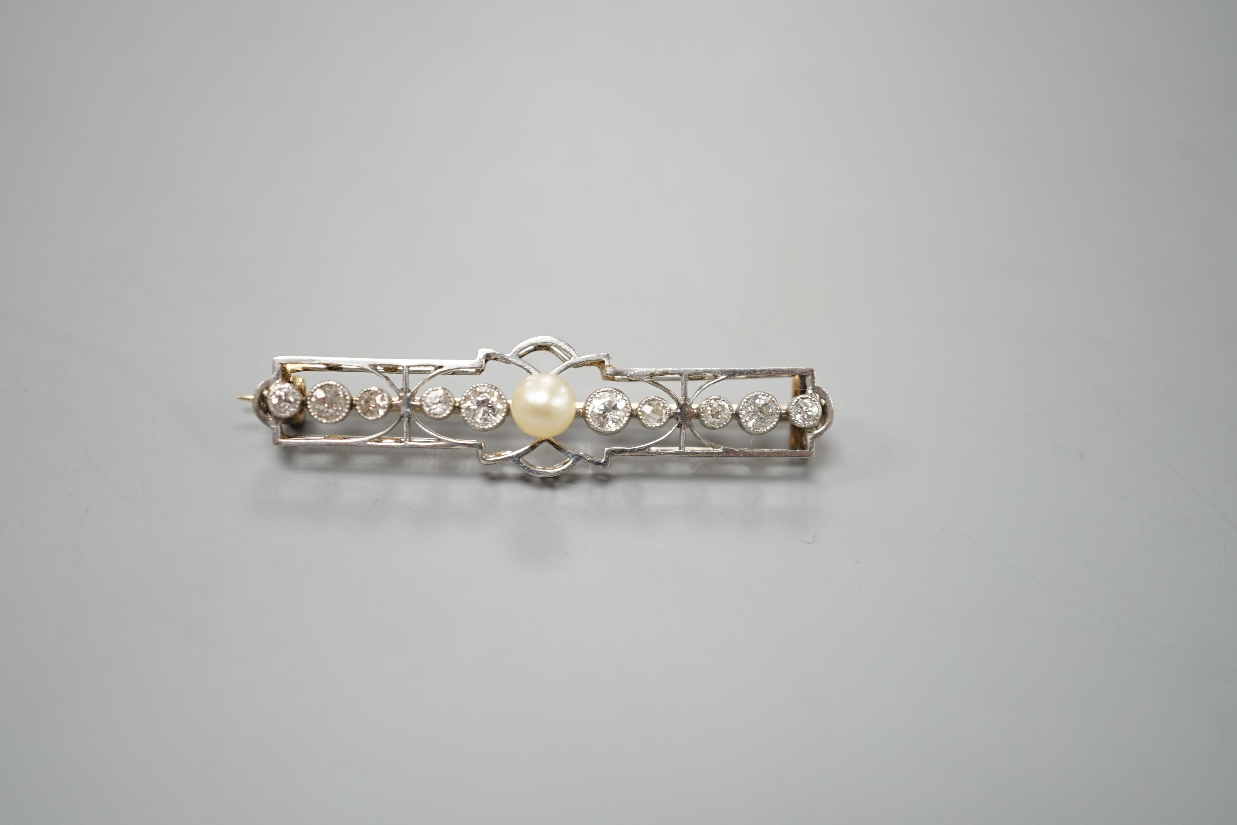 An early 20th century, yellow and white meta, cultured pearl and diamond set open work bar brooch, 41mm, gross weight 3.6 grams.
